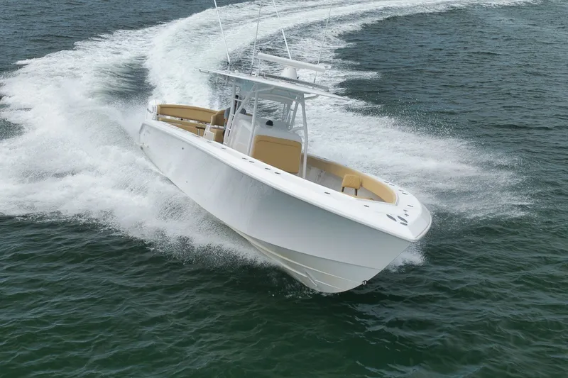 Slide: The Image of 2020 Bahama 41 boat cruising swiftly on open water, creating a dynamic wake. - 43