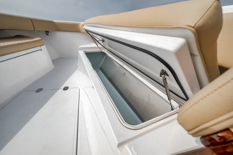 Slide: The Image of Open storage compartment on 2020 Bahama 41 boat with beige seating. - 21
