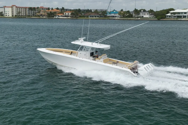 Slide: The Image of 2020 Bahama 41 boat cruising on water, showcasing sleek design and powerful engines. - 15
