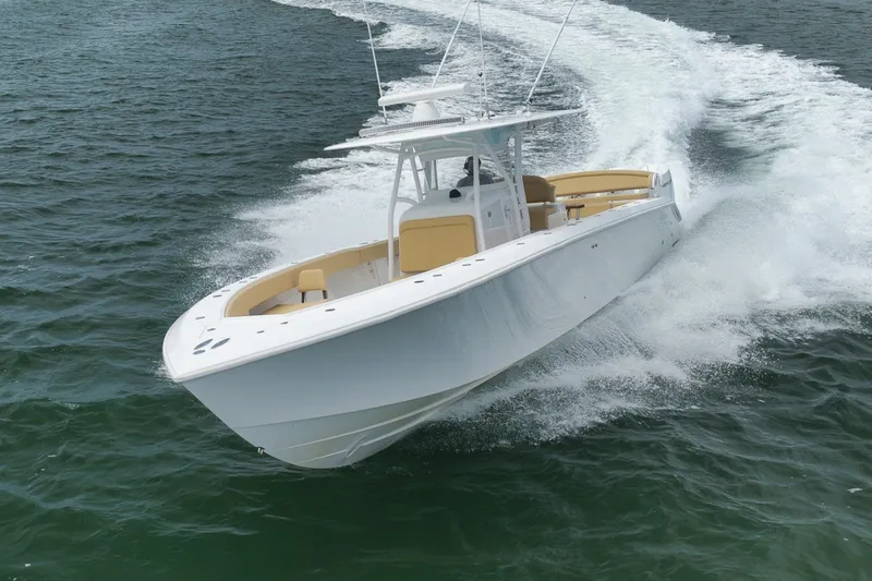 Slide: The Image of 2020 Bahama 41 boat cruising swiftly on open water. - 45