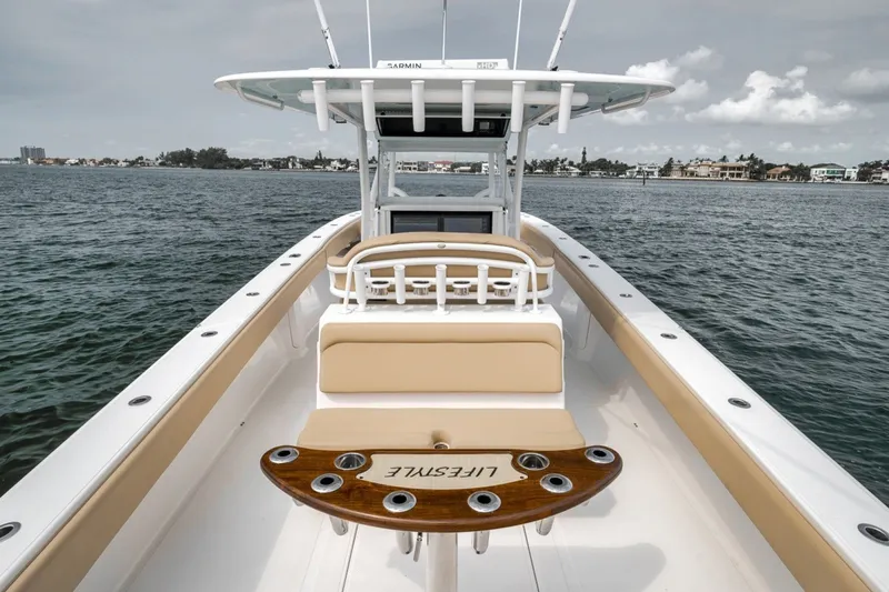 Slide: The Image of 2020 Bahama 41 boat with beige seating and fishing rod holders on open water. - 41