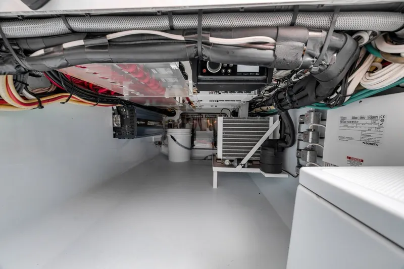 Slide: The Image of Engine room of a 2020 Bahama 41 boat, showcasing wiring and equipment. - 35