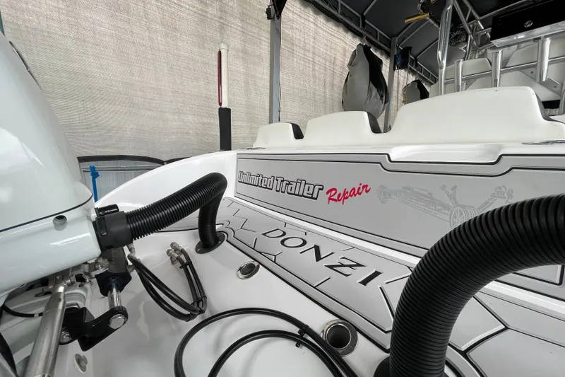 Slide: The Image of 1998 Donzi 29 ZF Cuddy boat interior with visible branding and equipment. - 59