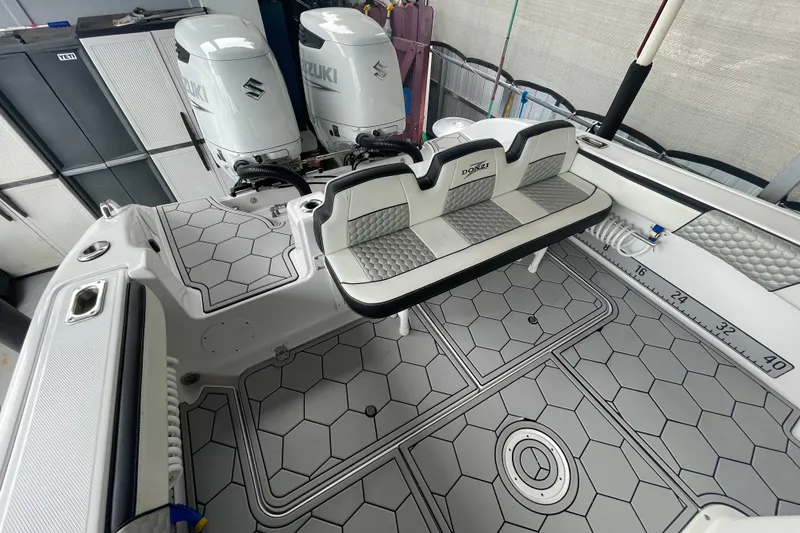 Slide: The Image of 1998 Donzi 29 ZF Cuddy boat interior with Suzuki engines and hexagonal flooring. - 32