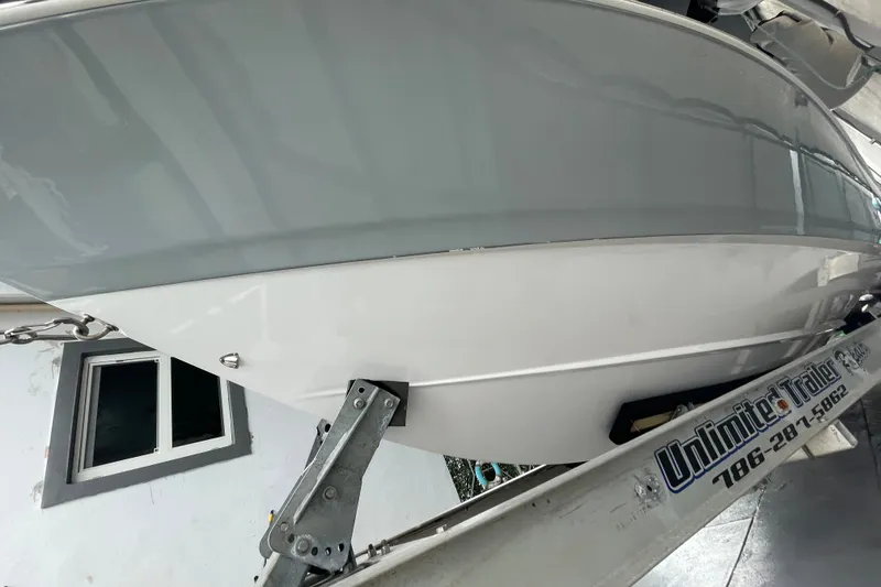 Slide: The Image of 1998 Donzi 29 ZF Cuddy boat on trailer, side view in storage. - 14