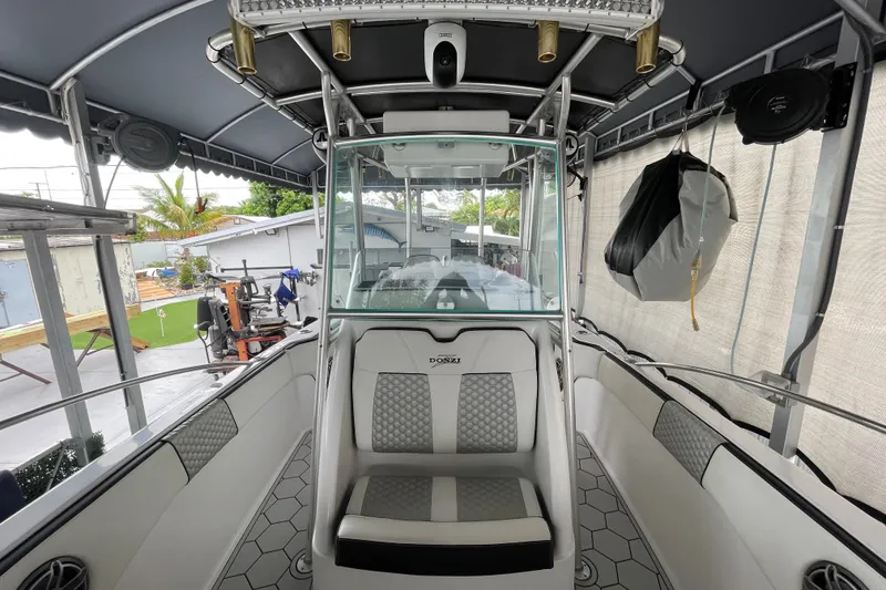 Slide: The Image of 1998 Donzi 29 ZF Cuddy boat interior with seating and canopy, showcasing sleek design. - 22