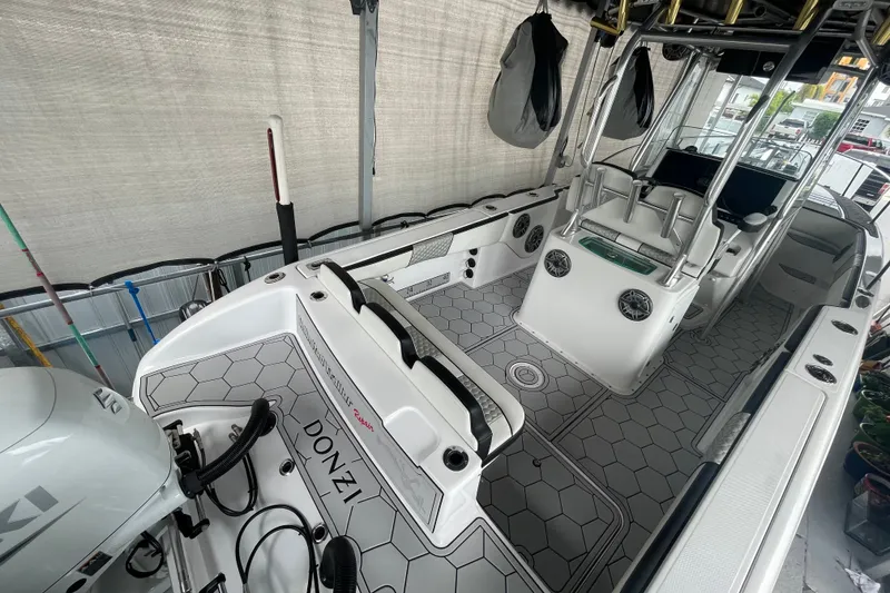 Slide: The Image of 1998 Donzi 29 ZF Cuddy boat interior with modern seating and hexagonal flooring design. - 28