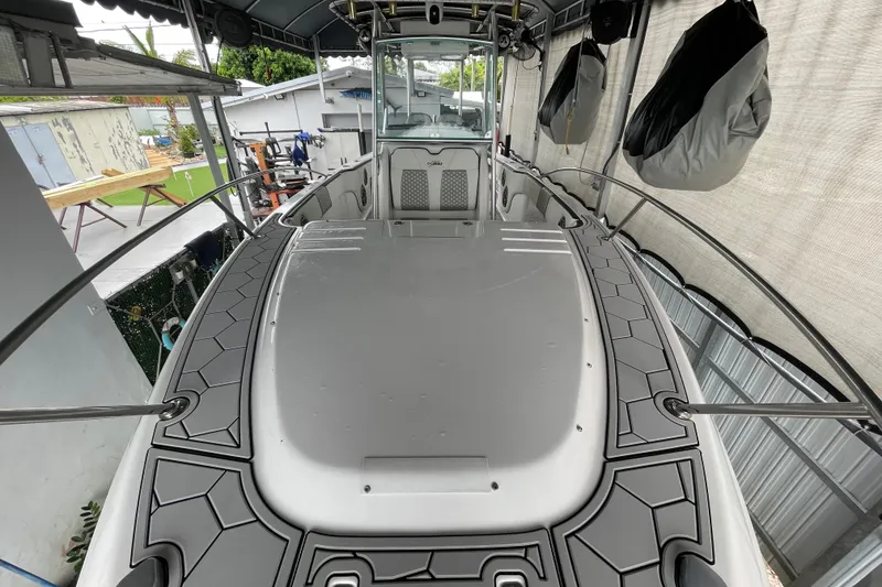 Slide: The Image of 1998 Donzi 29 ZF Cuddy boat in covered storage, showcasing sleek design and spacious deck. - 18