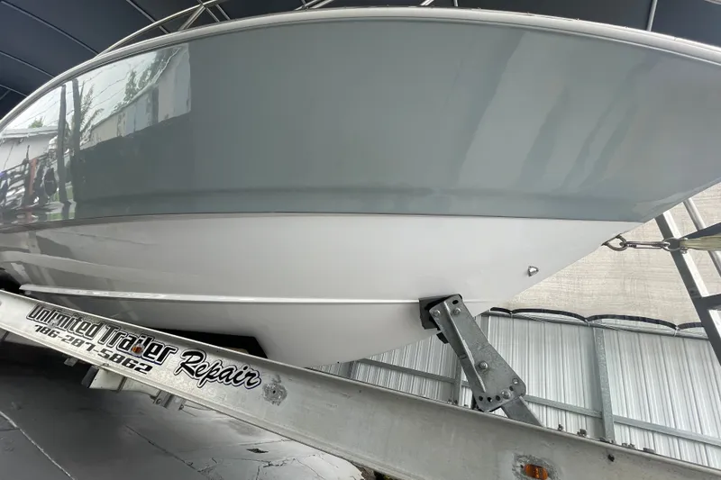 Slide: The Image of 1998 Donzi 29 ZF Cuddy boat on trailer in covered storage. - 15