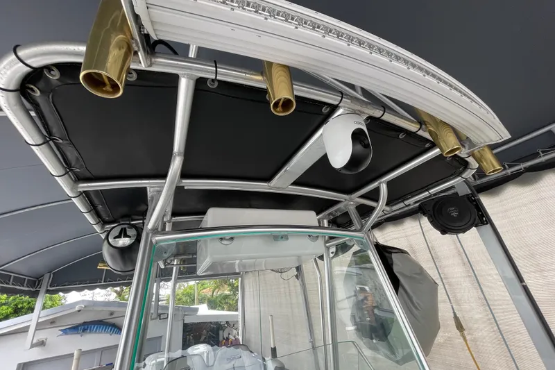 Slide: The Image of 1998 Donzi 29 ZF Cuddy boat with T-top and rod holders. - 57