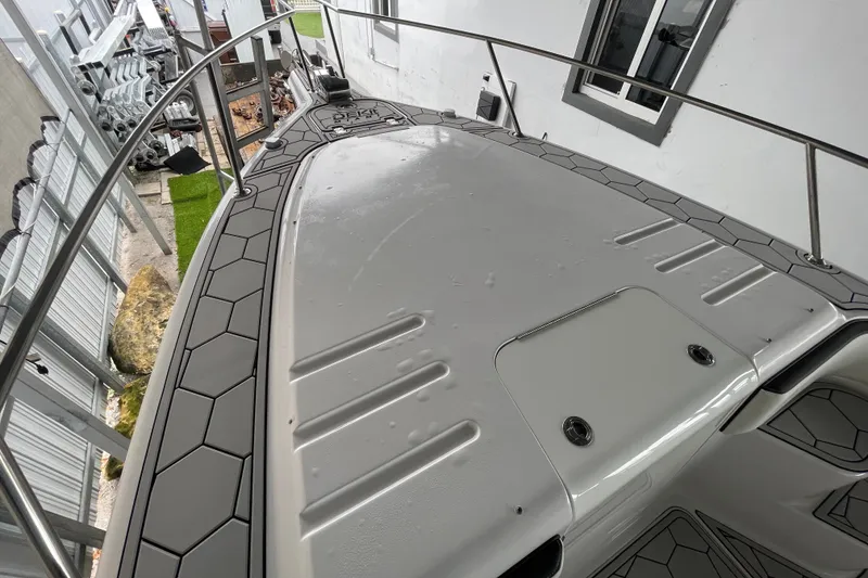 Slide: The Image of 1998 Donzi 29 ZF Cuddy boat deck with sleek design and railing. - 19