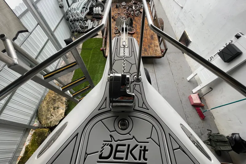 Slide: The Image of 1998 Donzi 29 ZF Cuddy boat deck with DEKit flooring, docked in a storage area. - 17