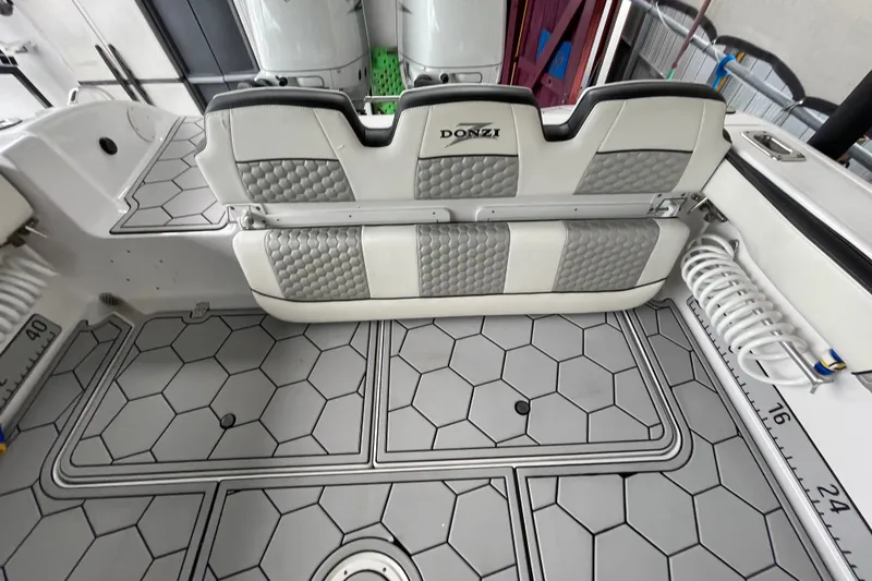 Slide: The Image of 1998 Donzi 29 ZF Cuddy boat interior with quilted seating and hexagonal patterned flooring. - 44