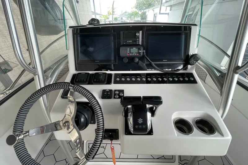 Slide: The Image of Control panel of a 1998 Donzi 29 ZF Cuddy boat with steering wheel and electronics. - 42