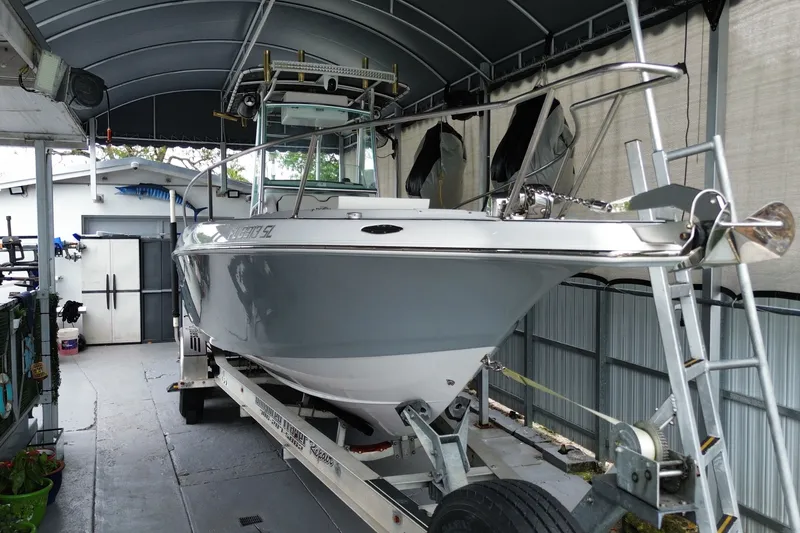 The Image of 1998 Donzi 29 ZF Cuddy boat on trailer in covered storage area. - 1