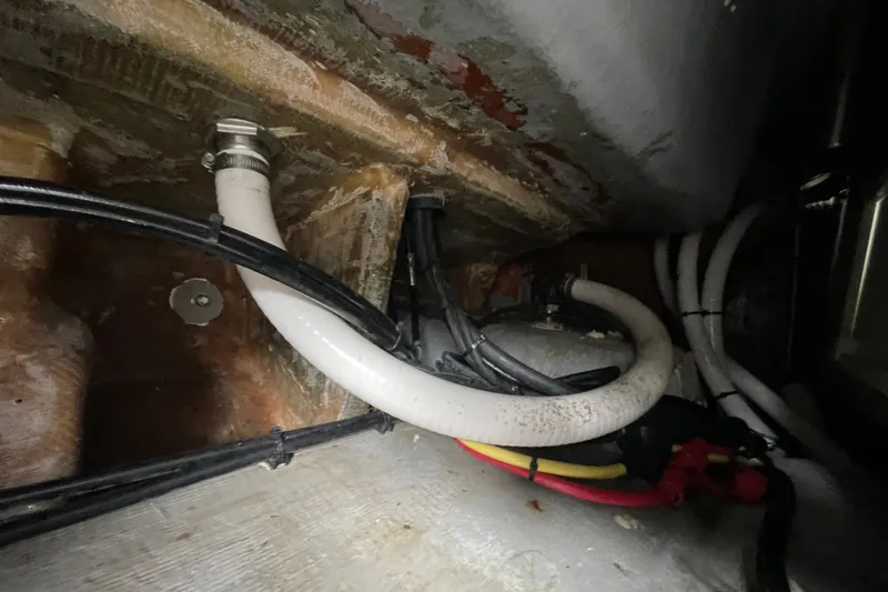 Slide: The Image of Bilge area of a 1998 Donzi 29 ZF Cuddy boat with hoses and wiring. - 51
