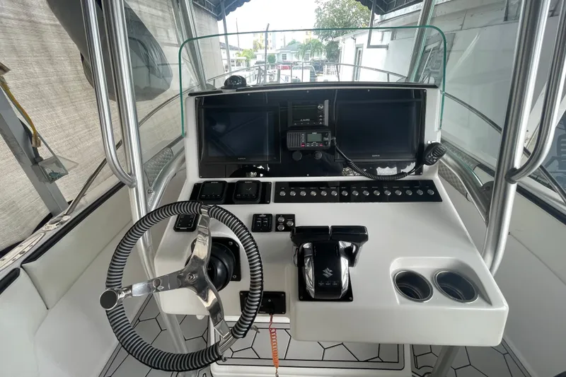 Slide: The Image of Cockpit of 1998 Donzi 29 ZF Cuddy boat with steering wheel and control panel. - 40