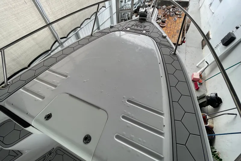 Slide: The Image of 1998 Donzi 29 ZF Cuddy boat deck with hexagonal pattern flooring. - 20