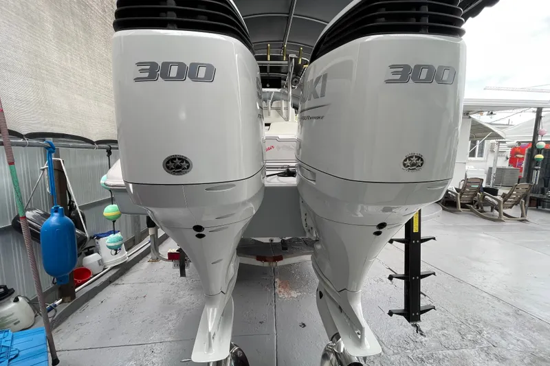 Slide: The Image of Twin Suzuki 300 outboard engines on a 1998 Donzi 29 ZF Cuddy boat. - 58