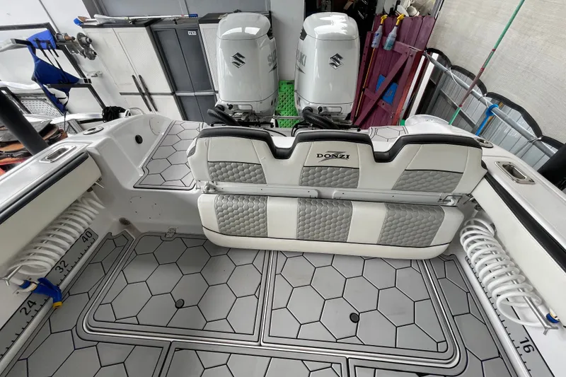 Slide: The Image of 1998 Donzi 29 ZF Cuddy boat interior with dual Suzuki engines and hexagonal flooring. - 45