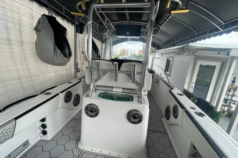 Slide: The Image of 1998 Donzi 29 ZF Cuddy boat interior with modern seating and audio system. - 33