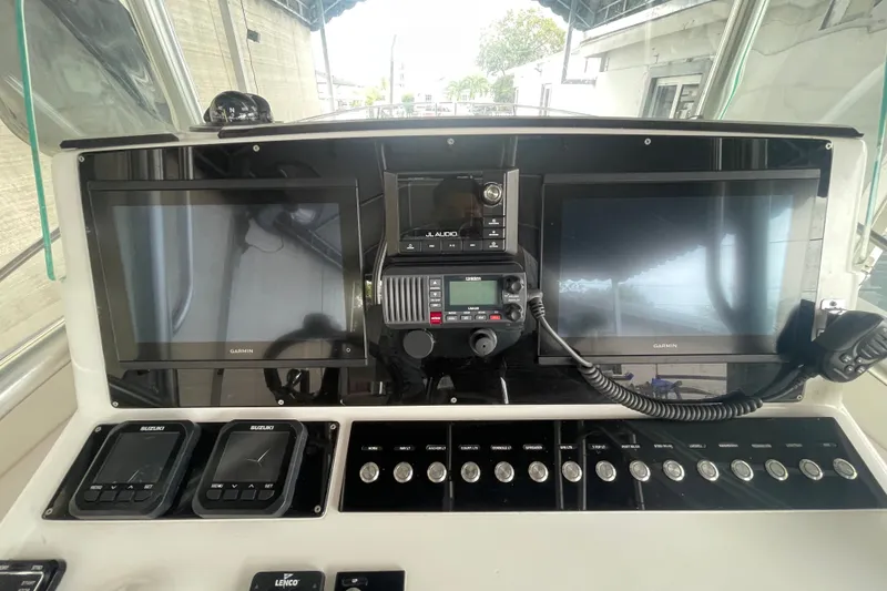 Slide: The Image of 1998 Donzi 29 ZF Cuddy dashboard with Garmin displays and marine radio equipment. - 41