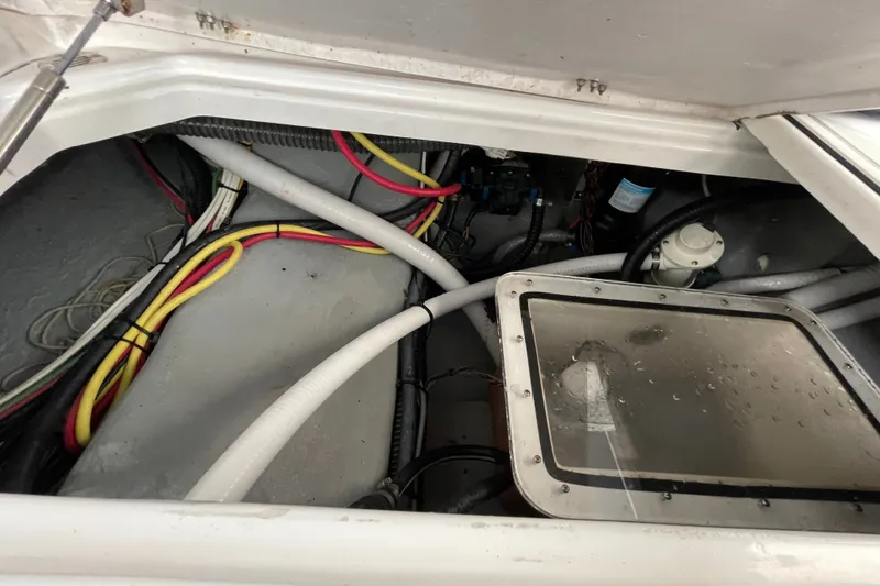 Slide: The Image of Engine compartment of a 1998 Donzi 29 ZF Cuddy with visible wiring and components. - 47