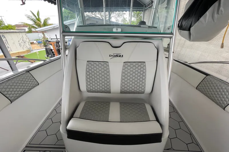 Slide: The Image of 1998 Donzi 29 ZF Cuddy boat interior with cushioned seating and modern design. - 21