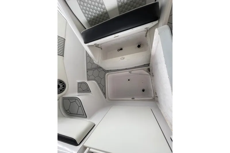 Slide: The Image of Interior view of a 1998 Donzi 29 ZF Cuddy boat, featuring storage compartments. - 26