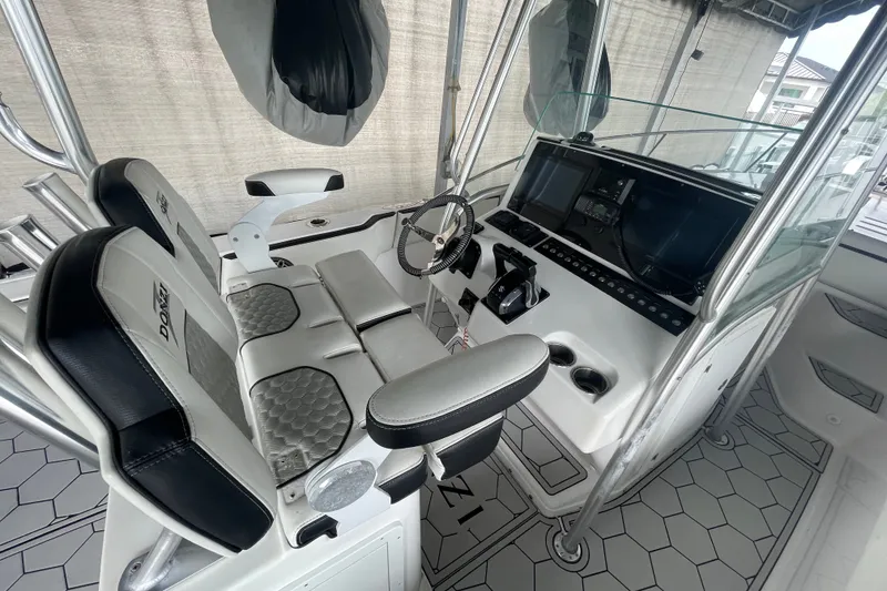 Slide: The Image of 1998 Donzi 29 ZF Cuddy boat cockpit with modern controls and seating. - 38