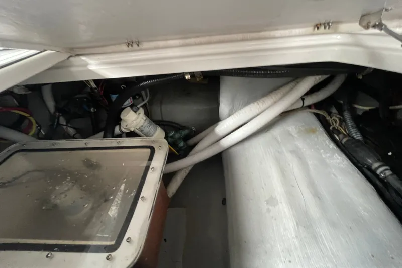 Slide: The Image of Engine compartment of a 1998 Donzi 29 ZF Cuddy boat, showing cables and components. - 46