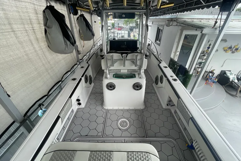 Slide: The Image of 1998 Donzi 29 ZF Cuddy boat interior with modern seating and hexagonal flooring design. - 31