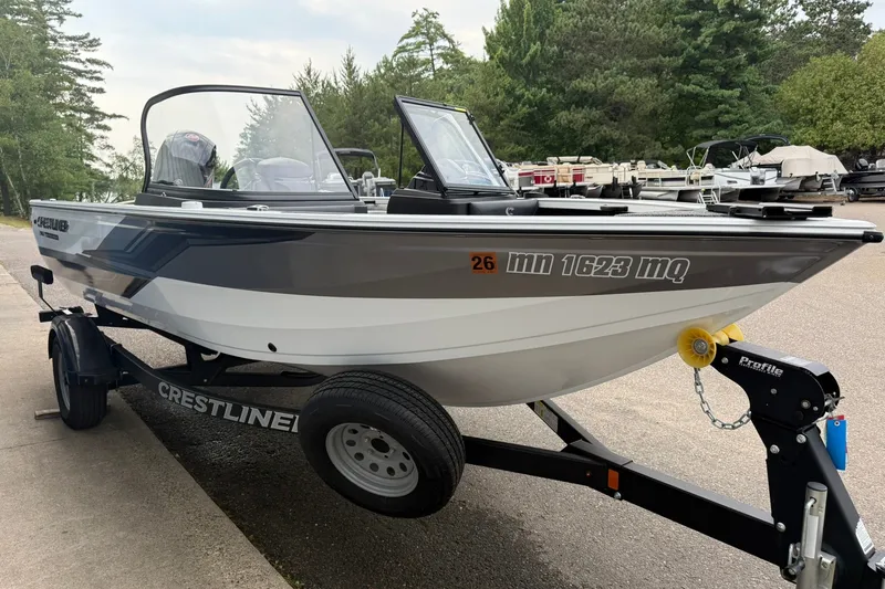 Slide: The Image of 2024 Crestliner 1850 Super Hawk boat on trailer, parked outdoors. - 5