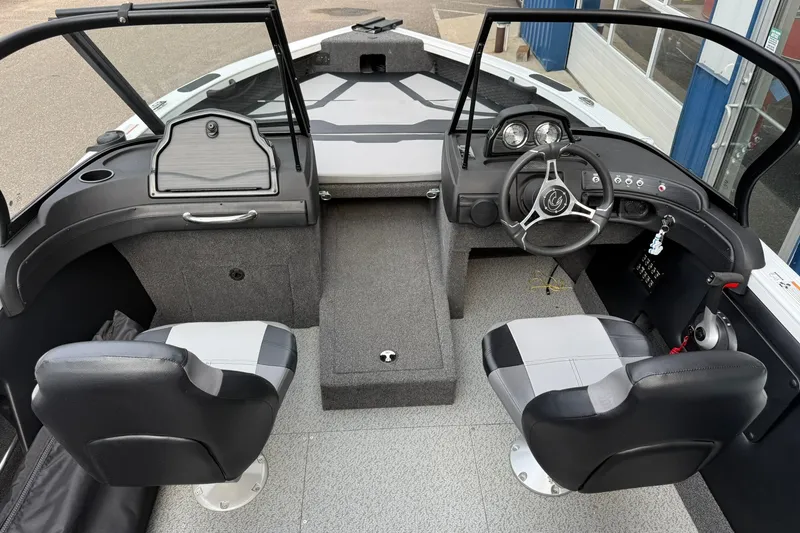 Slide: The Image of 2024 Crestliner 1850 Super Hawk boat interior with dual seats and modern dashboard. - 6