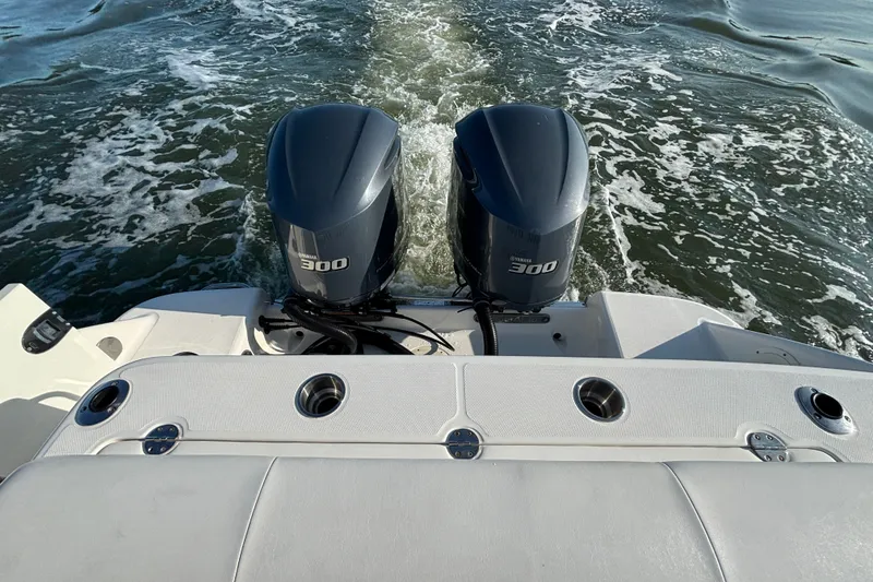 Slide: The Image of 2014 Robalo R300 Center Console with dual Yamaha 300 engines on open water. - 17