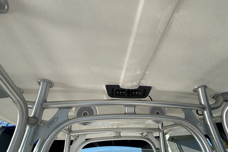 Slide: The Image of 2014 Robalo R300 Center Console boat's T-top with integrated speakers and control panel. - 31