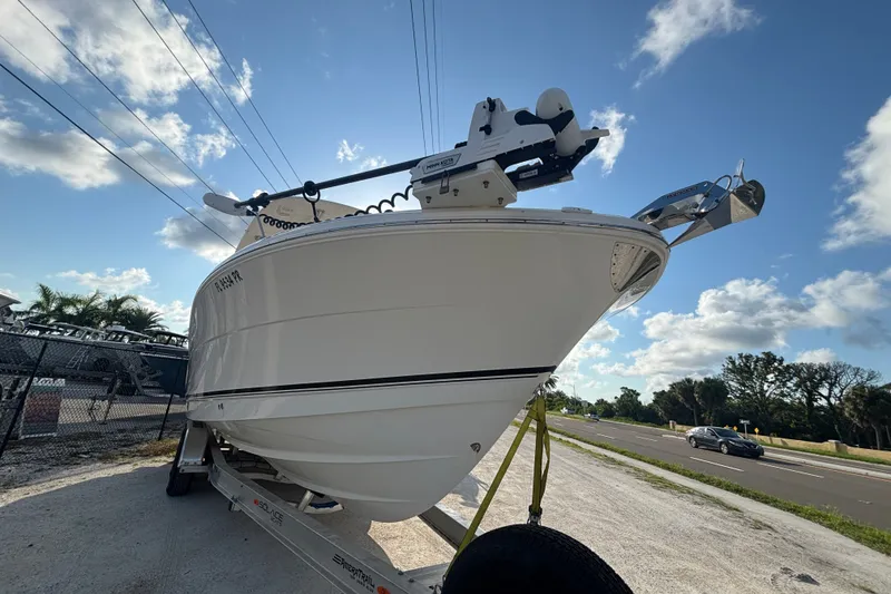 Slide: The Image of 2014 Robalo R300 Center Console boat on trailer under blue sky. - 1