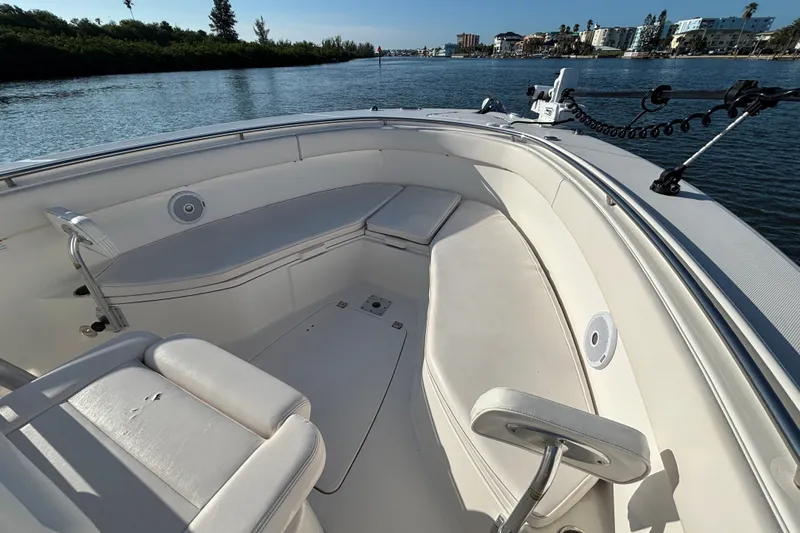 Slide: The Image of 2014 Robalo R300 Center Console boat interior with seating, on calm water. - 11