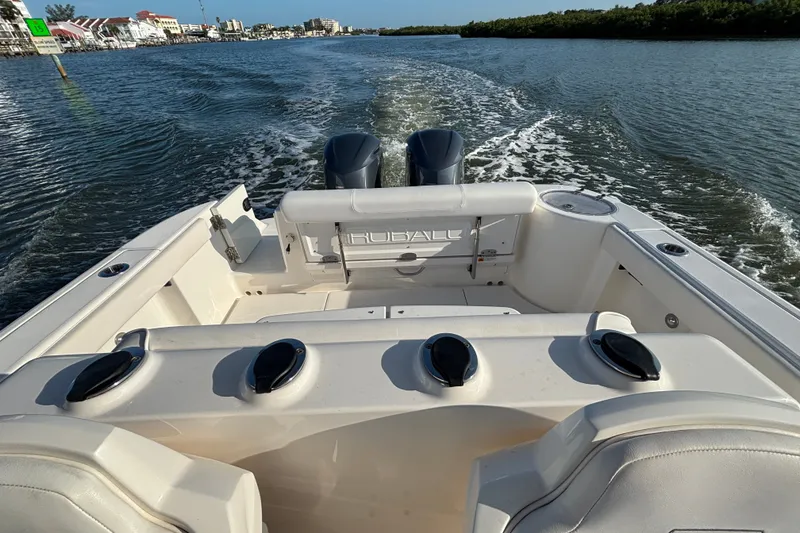 Slide: The Image of 2014 Robalo R300 Center Console boat cruising on a scenic waterway. - 25