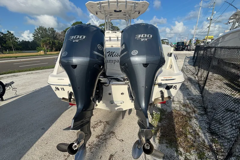 Slide: The Image of 2014 Robalo R300 Center Console with twin Yamaha 300 V6 engines, parked outdoors. - 3