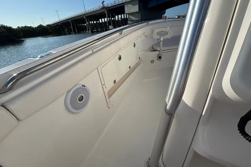Slide: The Image of 2014 Robalo R300 Center Console boat interior with speaker, near a bridge. - 30