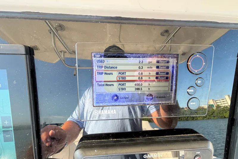 Slide: The Image of 2014 Robalo R300 Center Console dashboard with trip and engine data display. - 15
