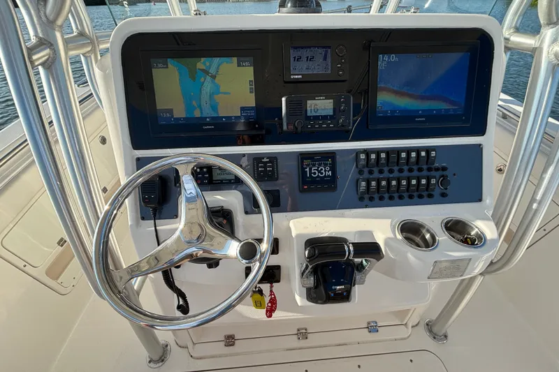 Slide: The Image of 2014 Robalo R300 Center Console dashboard with navigation screens and controls. - 21