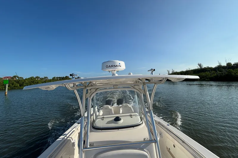 Slide: The Image of 2014 Robalo R300 Center Console boat cruising on a sunny day with Garmin equipment. - 13