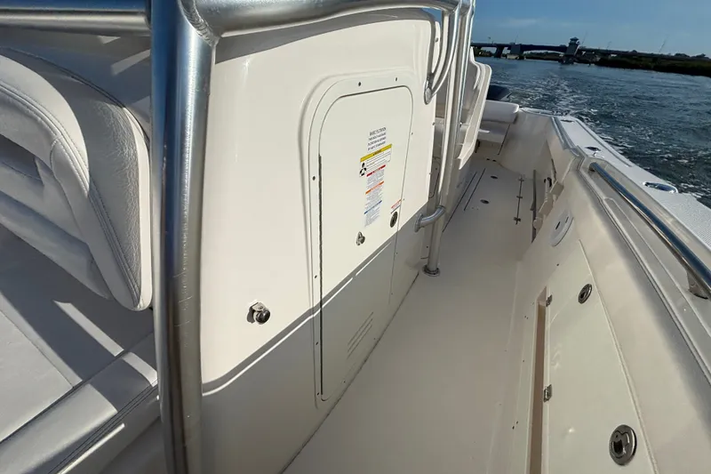 Slide: The Image of 2014 Robalo R300 Center Console boat interior with sleek design and sturdy railings. - 4