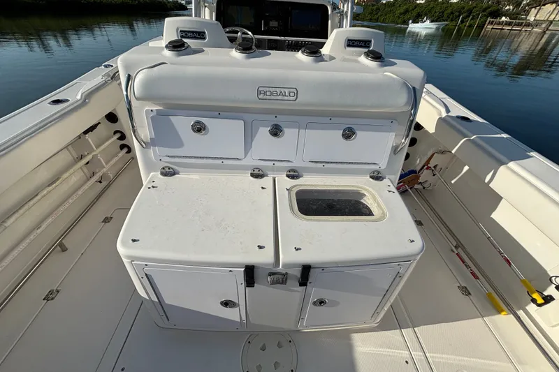 Slide: The Image of 2014 Robalo R300 Center Console boat interior with storage compartments and fishing equipment. - 27