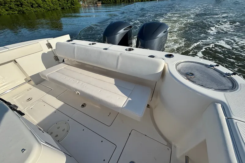 Slide: The Image of 2014 Robalo R300 Center Console boat with dual engines and spacious seating area. - 24
