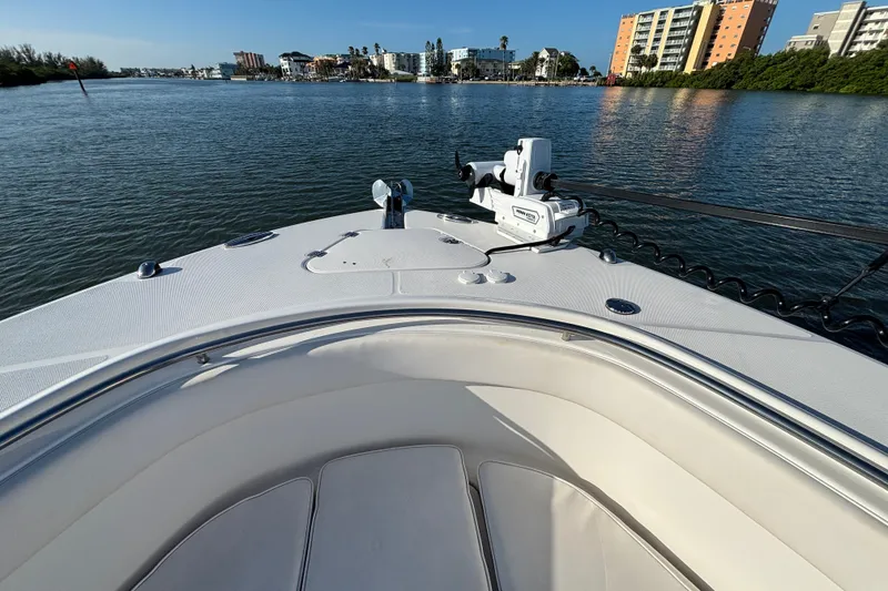 Slide: The Image of 2014 Robalo R300 Center Console boat on calm water near coastal buildings. - 7