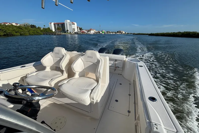 Slide: The Image of 2014 Robalo R300 Center Console boat cruising on a scenic waterway. - 26
