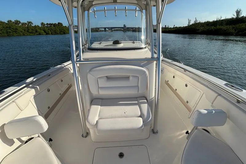 Slide: The Image of 2014 Robalo R300 Center Console boat interior on calm waterway. - 12